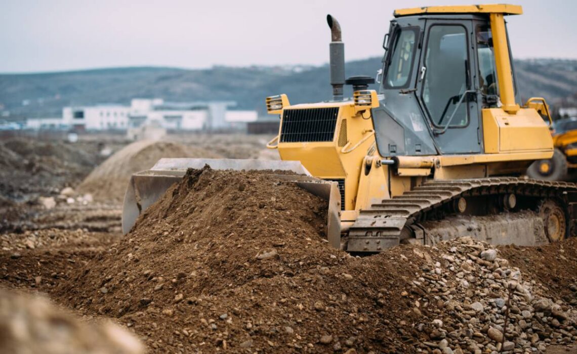 What is the difference between an excavator and a backhoe